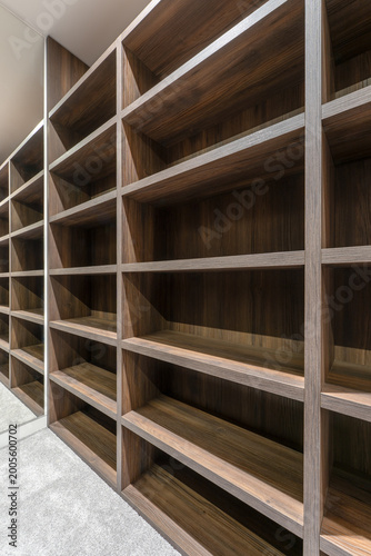 Canvas Print Modern walk in closet with custom wooden shelving system empty wardrobe storage