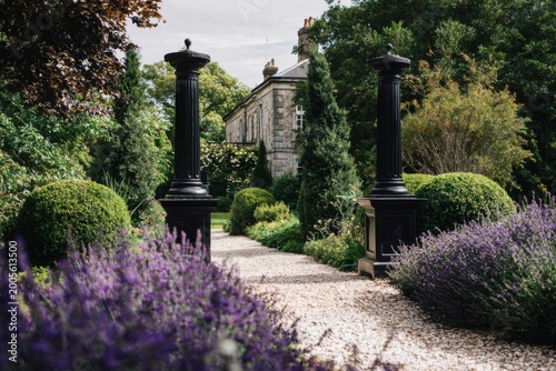 Paths lead through green gardens to a building in autumn with flowers blooming and trees offering shade in a quiet setting during daylight hours