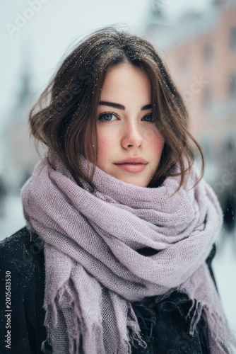 Beautiful Young Woman Wearing Cozy Scarf in Snowy Winter City Portrait
