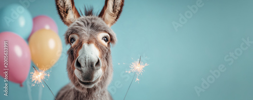 Funny cute donkey animal character with balloons and burning sparklers around against blue background with copy space. Birthday party banner for kids.