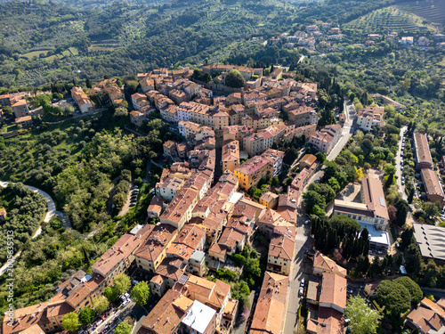 High angle drone view of Castagneto Carducci ancient village and its roofs in Italy