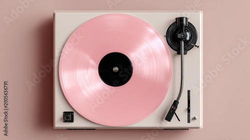 Turntable with pink vinyl record on beige background, music player device for audio playback, retro style record player with tonearm and cartridge in minimal setup.