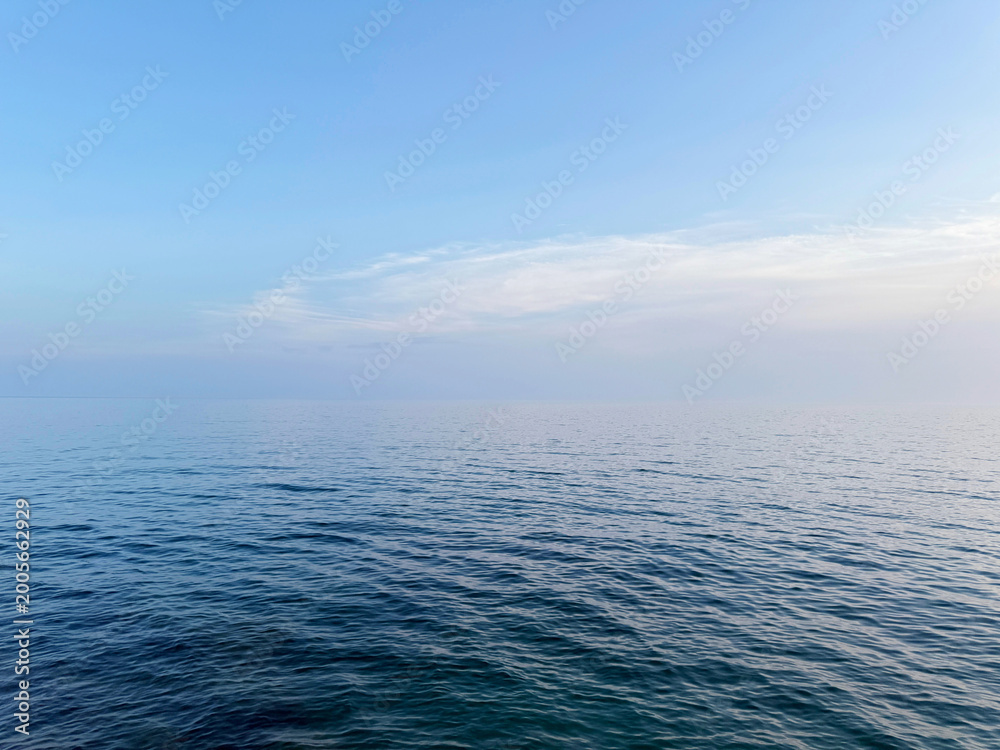 Fototapeta premium Open sea tranquil blue water and clear sky.
