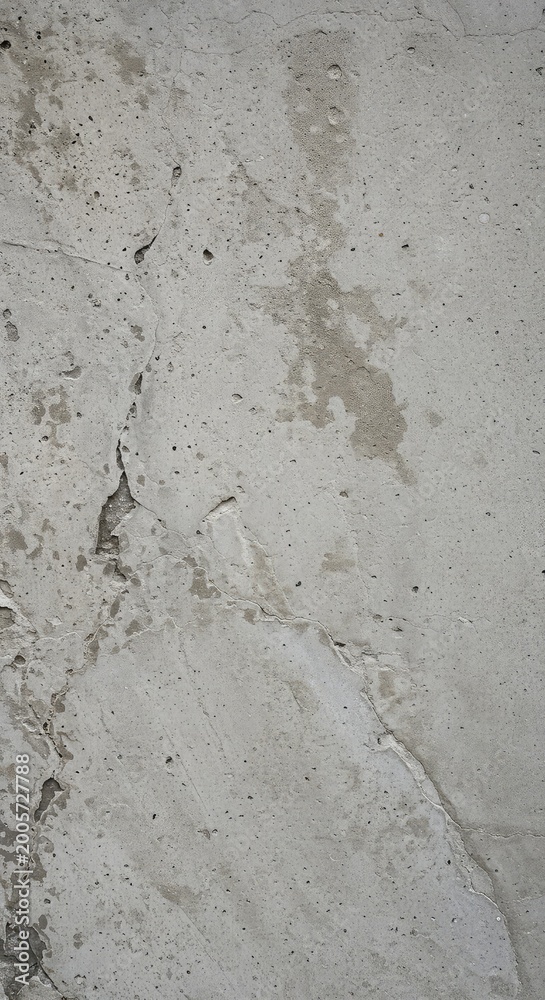 Fototapeta premium A detailed, close-up photograph of a weathered gray concrete wall surface displaying rough, gritty, and aged imperfections and structure, rough, material, urban