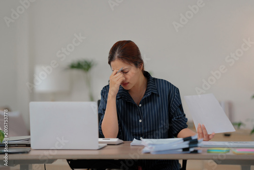 Bored unmotivated female working at home