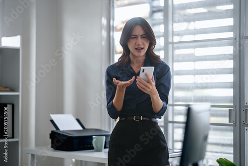 Serious young asian business woman received mail with bad news Free Download Serious young asian business woman received mail with bad news - GFXLoad