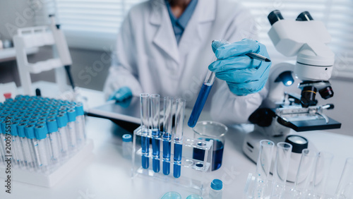 Scientist analyze biochemicals in a laboratory for health care research progress