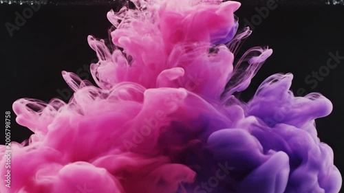 Abstract ink explosion dynamic colorful smoke cloud against black background