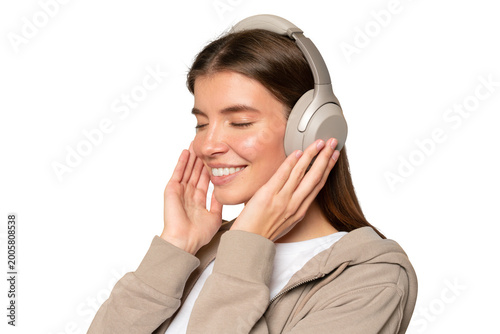 Woman with closed eyes in wireless headphones listening to relaxing sounds after stressful work day