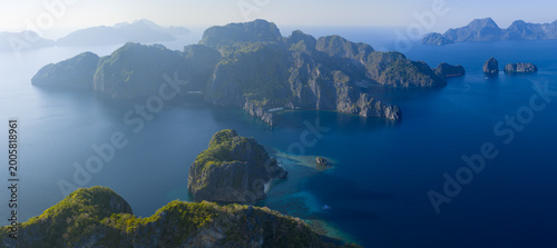 Dramatic limestone islands rise in Bacuit Bay, El Nido. This scenic area in the Philippines is a popular vacation destination due to its beautiful coral reefs, beaches, and hidden lagoons.