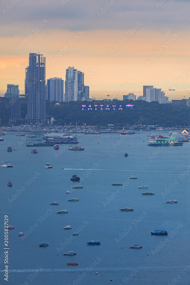 Obraz premium Pattaya cityscape with numerous boats in the bay at dusk