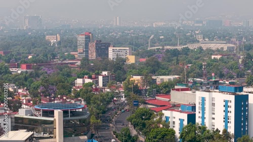 Aerial shot of south Mexico City skyline with smog and traffic