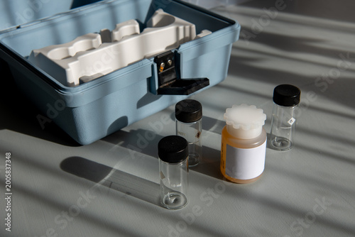 Portable water testing kit with sample vials and container