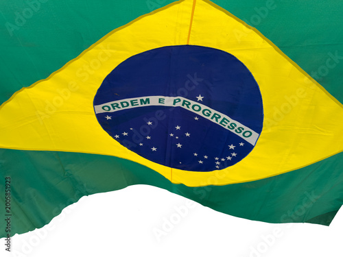 Brazilian flag cut out and isolated is waving in the wind, national symbol of Brazil with green, yellow and blue colors, representing patriotism, culture, identity and government.