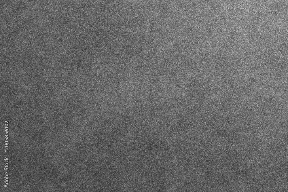 Fototapeta premium A simple dark grey grainy texture provides a subtle and versatile background.