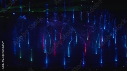 Stunning night drone footage captures Warsaw's magical glow over the Vistula. Park Fontann's lights dance on water, illuminating bridges and skyline in cinematic aerial sweeps