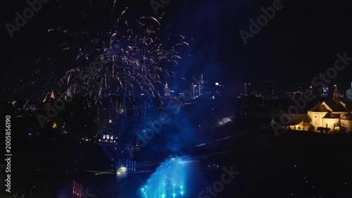 Stunning night drone footage captures Warsaw's magical glow over the Vistula. Park Fontann's lights dance on water, illuminating bridges and skyline in cinematic aerial sweeps