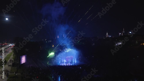 Stunning night drone footage captures Warsaw's magical glow over the Vistula. Park Fontann's lights dance on water, illuminating bridges and skyline in cinematic aerial sweeps
