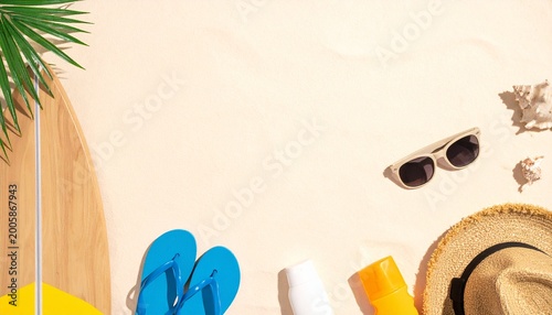 Summer beach vacation setup with sunglasses, flip flops, and sunhat on sandy shore