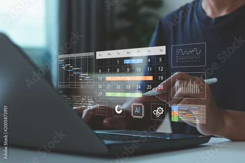 Businessman using laptop with digital calendar, data analytics dashboard and AI interface, project management, scheduling, productivity, modern technology workflow in smart business office environment
