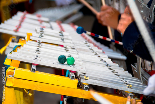 Marching band glockenspiel performance in outdoor parade with natural light