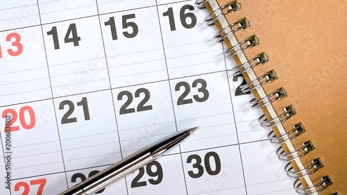 Calendar with pen and spiral notebook, schedule and deadline management concept