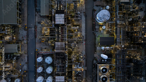 Aerial view Oil and Gas refinery industrial at night, Oil and Gas refinery plant form industry, Refinery plant factory white oil storage tank at night, Oil and Gas refinery plant from industry zone.