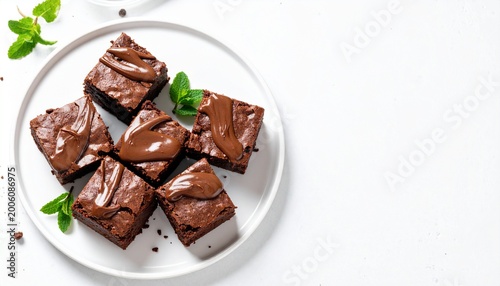 Top view close-up of chocolate brownies with ganache on a white plate, white background, soft natural light, high detail, realistic, minimal composition