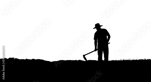 Black silhouette of a farmer working in a field with a hoe