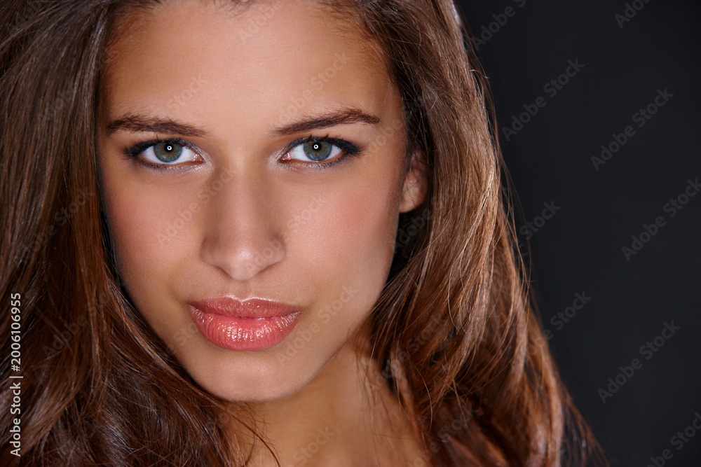 Naklejka premium Woman, makeup and beauty in studio portrait, glow and transformation with lipgloss by black background. Girl, person and model with pout, lipstick and facial cosmetics with confidence in Italy