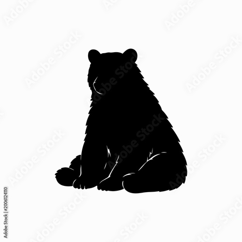 Black bear sitting in relaxed pose