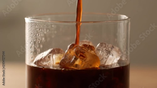 Iced coffee splash with ice cubes and dynamic liquid motion top view refreshing cold beverage close up