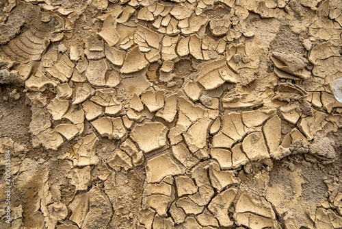 Cracked dried mud texture after flood in West Sumatra, Indonesia, showing natural pattern of dried sediment and environmental impact of extreme weather