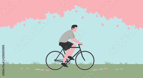 Man riding bicycle under cherry blossoms in spring park