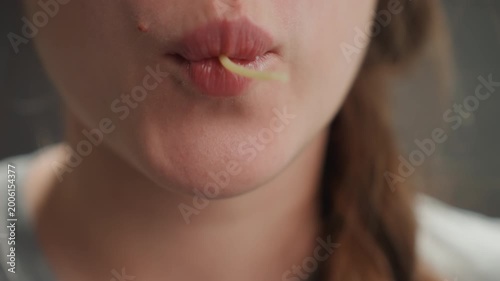 Pregnant woman rejoicing. Pregnant female relishing pasta with gleeful enthusiasm in studio setting. An expectant woman enjoys tasting spaghetti with playful joy during cheerful studio moment