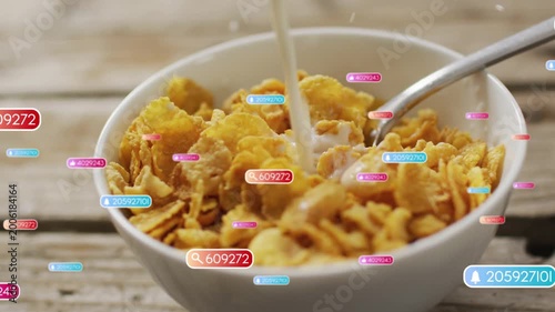Badges appearing, milk pouring over white bowl of corn flakes, flakes darkening to visualize data