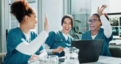 Bild auf Leinwand Happy women, nurse and celebration with high five for teamwork, winning or success in hospital
