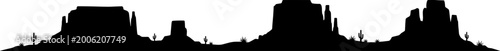 Desert buttes and saguaro cacti silhouette against horizon