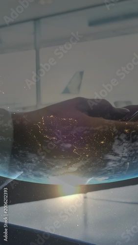 Vertical video: Globe overlay appearing, hand lifting phone and tapping, checking flight status
