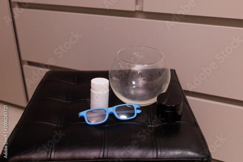 Items are placed on a black stool in a room