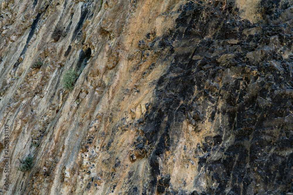 Naklejka premium Dark Volcanic Rock Texture Background - Natural Stone Surface Pattern