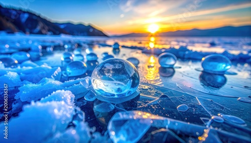 A breathtaking view of Baikal Lake's frozen surface adorned with spherical ice formations reflecting a vibrant sunset.
