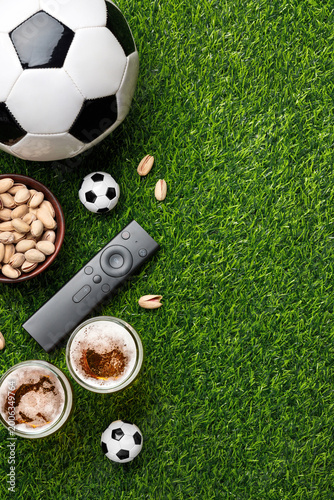 Konstfotografi A soccer balls with two glasses of beer, pistachios bowl and TV remote create a perfect match day watching atmosphere