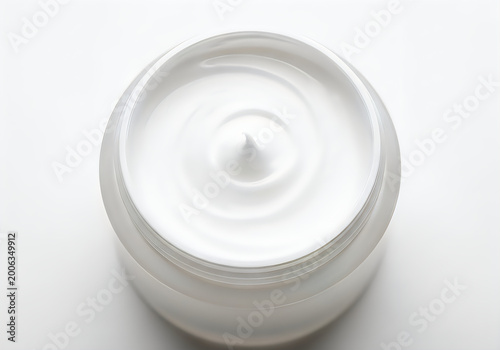 White face cream in a round cosmetic jar from above isolated on white background