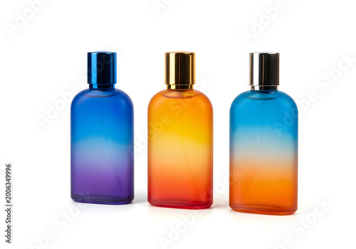 Three colorful glass perfume bottles with metallic caps isolated on white background