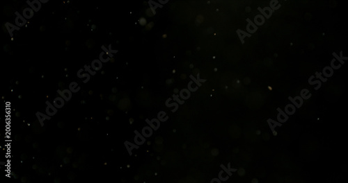 Foto Close-up of floating dust particles in air, isolated on black background