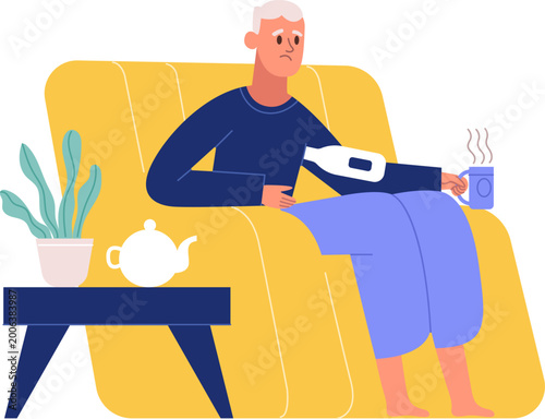Man sitting on armchair holding a hot drink and thermometer under arm feeling unwell