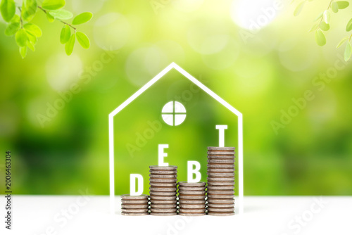 Wooden blocks spelling debt with house icon. Mortgage debt and financial burden concept