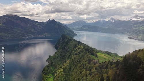 Aerial Drone Panorama of Lake Lucerne with Forested Rocky Peninsula and Swiss Alpine Peaks, Switzerland