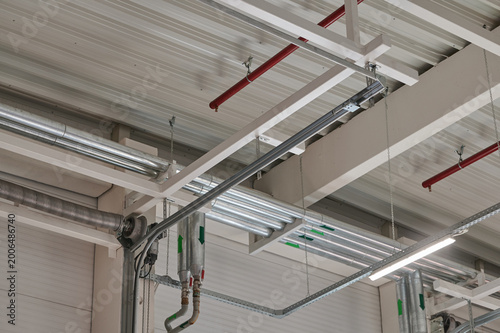 Pipes and lighting in an industrial ceiling space